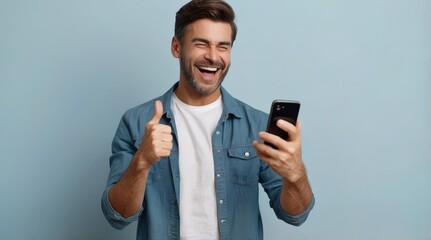 Happy delighted satisfied adult man looking at mobile phone screen gesturing yes thumb up winning pose, isolated background. Overjoyed excited guy make gesture read message about happy good news