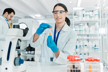 Poster - Woman, vial and microscope in laboratory for science, problem solving and solution at table. Scientist, testing or PPE in research facility for medicine engineering, healthcare or forensic innovation