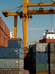 Sticker - Crane loading cargo containers onto a ship at a busy port.