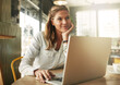 © ThurstanJam/peopleimages.com - Coffee shop, thinking and business woman on laptop for remote work, typing email and networking. Freelancer, restaurant and person on computer in cafe for internet, research project and proposal