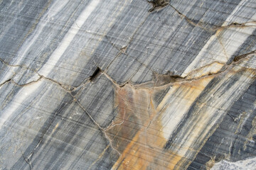 Aufkleber - The surface of marble reveals intricate natural veins and textures highlighting its rich colors and patterns, found in a quarry setting