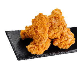 Fried chicken wings with dipping sauce on black stone plate