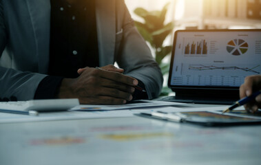 Wall Mural - Close up of Business team analyzing income charts and graphs with modern laptop computer. Business analysis and strategy concept.