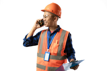 Asian male construction worker in full dress is on a phone call while carrying a clipboard, industrial and construction concept, isolated on white background.