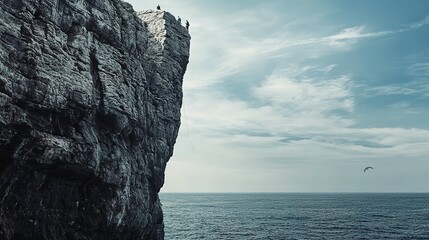 Wall Mural - Climbers on a steep rock face above the sea