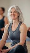 © Thuy Nguyen - Smiling mature woman sitting in yoga class