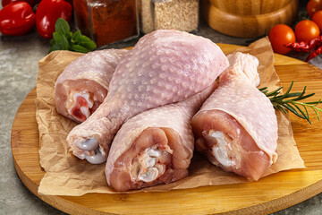 Wall Mural - Raw uncooked chicken drumsticks over board