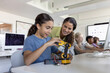© ReeldealHD images - School girl showing teacher the robotic arm she is working on