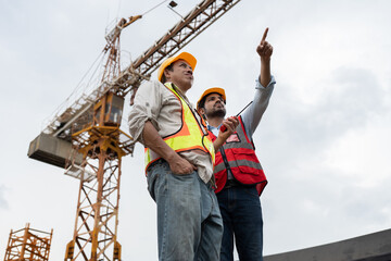 Wall Mural - Asia engineer man worker and India engineer man working with crane background	