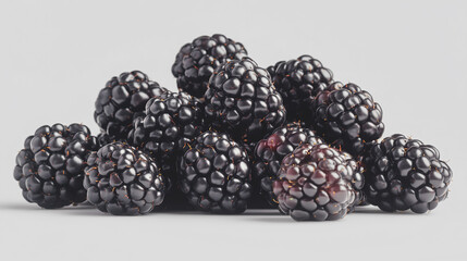 Fresh blackberries arranged in a pile on a light background, showcasing their glossy texture