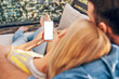 © baranq - Mobile phone mock-up. Couple hogging on terrace holding smartphone with blank empty screen.