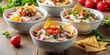 © NorthStar Creations - Vibrant Salad Composition Four Bowls of Tortilla Chip Salad with Yogurt, Cherry Tomatoes, Radishes, and Parsley on a Rustic Wooden Table, Soft Lighting Enhances Freshness and