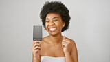 A joyful african american woman with curly hair holds a comb against a white background, exuding beauty and positivity.