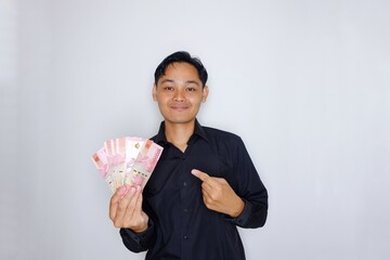 Random expression of adult Asian Indonesian man while holding banknotes isolated on white background