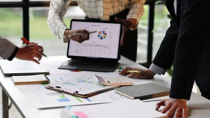 Canvas Print - Businesswoman collaborating on data analysis during office meeting. Three businesswomen analyzing charts and graphs on a laptop during a collaborative office meeting, discussing and pointing at data.