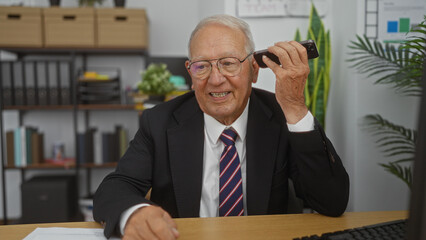 Wall Mural - Elderly caucasian man in a suit, speaking on the phone in a modern office with shelves, plants, and documents in the background.