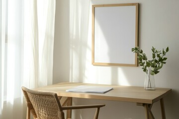 A minimalist workspace featuring a sleek, light wood desk with a simple wooden-framed blank