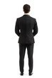 © Oksana - Corporate businessman in black suit standing back view isolated on white background