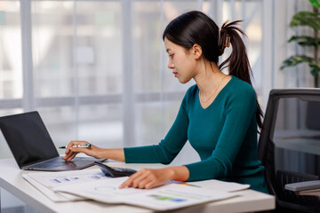 Wall Mural - Accountant working on desk using laptop documents calculator to calculate financial report in office business accounting finance concept
