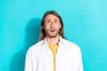 Wall Mural - Photo of funky cool guy dressed white shirt looking up emtpy space isolated teal color background