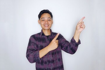 Portrait of a handsome Indonesian man in a purple flannel shirt, posing randomly on an isolated white background