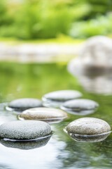 Sticker - Serene Pond Scene with Smooth Stones Reflecting Tranquility and Natures Beauty in a Calm Water Surface