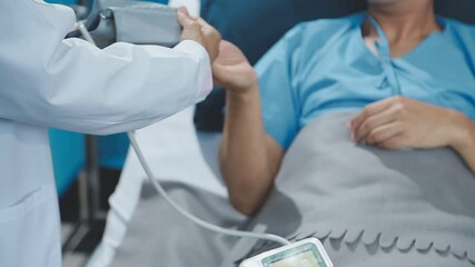 Wall Mural - Female doctor using sphygmomanometer with stethoscope checking blood pressure to a patient in the hospital