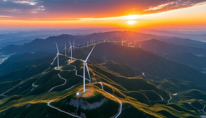 Wall Mural - Stunning sunset over a vast wind farm in mountainous terrain, blending sustainable energy with breathtaking natural beauty