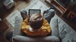 © GoodandEvil - Child sitting in a chair with a tablet, top view.
