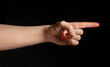 © bergamont - pointed index finger hand gesture on black background