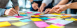 © Who is Danny - Businesspeople brainstorming with colorful sticky notes in a collaborative workshop setting.