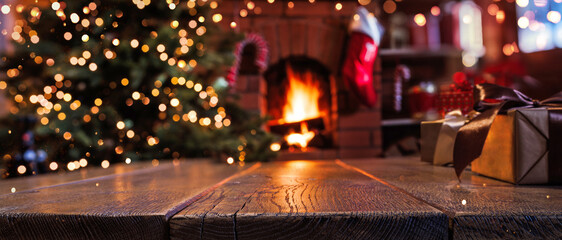 Wall Mural - christmas tree with decorations near fireplace with fire. holiday background with gifts on wooden ba