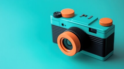 Wall Mural - A teal and orange vintage-style camera with black accents sits on a turquoise background, ready to capture memories.