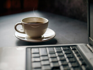 Wall Mural - Relax during business work concept, americano coffee cup and black coffee cup aromatic and laptop computer in morning