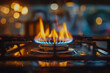 © TESS - Flames rising from a gas burner on a kitchen stove, with warm ambient lighting and a blurry background.