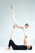 © danmorgan12 - International Sportive Couple of Asian Man and Caucasian Woman Performing As Ballet Dancers On Grey in Studio During Suppots As Classical Dance