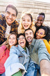 © Davide Angelini - Multi racial friends taking selfie picture with smart mobile phone - Group of young people smiling at camera outside - Vertical photo