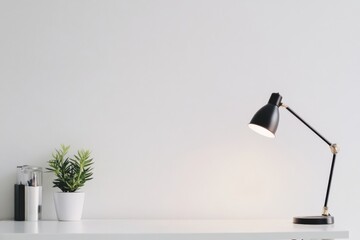 Aufkleber - A clean and organized minimalist desk featuring a potted plant, a pen holder with writing utensils, and a classic black desk lamp, creating a modern workspace ambiance.