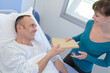 © auremar - giving a book to ill patient in hospital