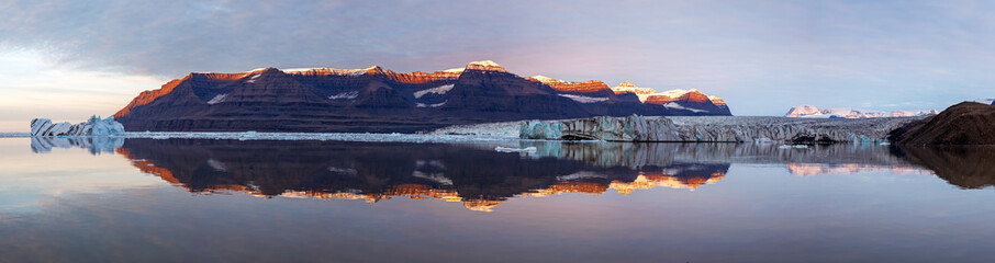 Wall Mural - a panorama of vikinge bay, scoresby sund, greenland, showing icebergs, mountains, a glacier, and pol