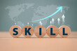 © FON's Fasai - Skill competency development concept. Leadership thinking upskill. Wooden with soft skill digital icon on world map background. Education learning talent, up new ability training technology evolution
