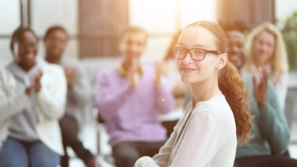 Wall Mural - Smiling businesswoman in glasses looking at camera at a seminar