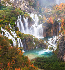 Wall Mural - Scenic Autumn Waterfall in Serene Forest Setting