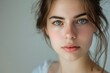 © Alena - A close-up shot of a young woman's face with bright blue eyes