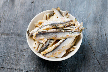 Marinated anchovies in vinegar in a white bowl