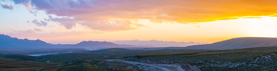 the picturesque sunset colors the mountain landscape with bright orange shades, creating a spectacul