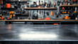 © Daniel - A blank metal tabletop with blurred automotive tools and parts in the background.