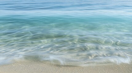 Wall Mural - A serene view of clear water gently lapping against a sandy beach.