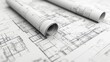 © Nathan - Detailed architectural blueprints rolled out on a flat surface, showcasing intricate designs and plans.