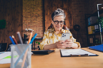 Poster - Photo of successful senior lady boss sitting armchair modern loft interior office indoors workstation workspace